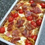 Easy baked feta pasta recipe with tomatoes and basil. One of the easiest easy college meals your husband will love! Get the recipe now.