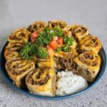 Easy Taco Pinwheels recipe! Cream cheese, cheddar, olives, and taco seasoning rolled in tortillas. Perfect party appetizers, tailgate food, or yummy snacks. Get the recipe now!
