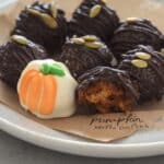 Easy no-bake pumpkin Oreo balls! A simple Halloween dessert recipe with cream cheese, orange chocolate, pretzel sticks, and green icing. Perfect for a quick and delicious Halloween treat!