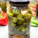 Sweet & Spicy Pickled Jalapeños Recipe! Add these easy homemade jalapeños to salads, tacos, and burgers for a delicious kick. Ready in just 10 minutes!