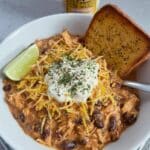 Easy 5-ingredient Crockpot White Chicken Chili recipe! This healthy and fast dinner is made with chicken breasts, taco seasoning, ranch seasoning, black beans, corn, Rotel tomatoes, and cream cheese. Perfect for fall meal prep and easy weeknight dinners!